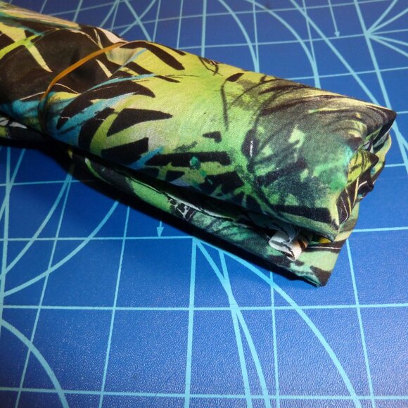 Fabric with a floral pattern transitioning from greens to blues - Picture 2 of 3